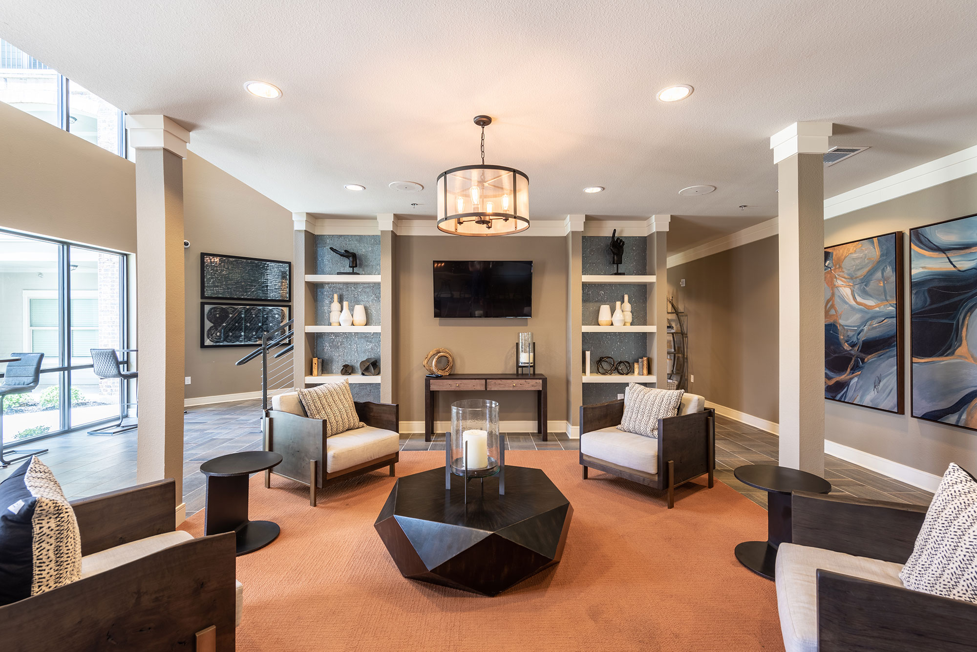 Clubhouse lounge with arm chairs and TV