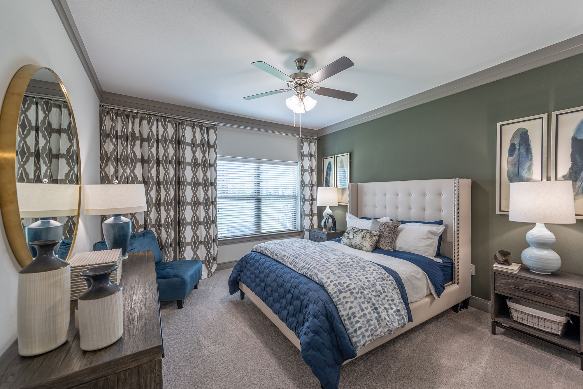 bedroom with green accent wall and large window